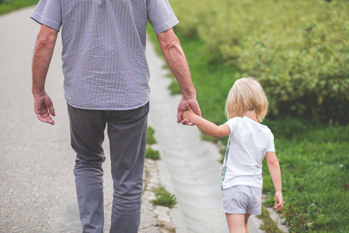 https://www.pexels.com/photo/man-and-child-walking-near-bushes-during-daytime-167300/